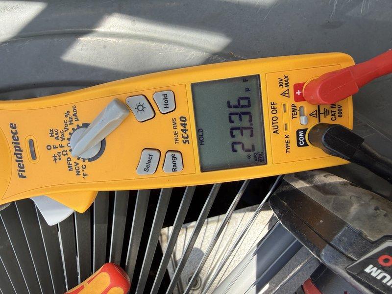 Responded to service call for second opinion on non-cooling residential air conditioning system over 10 years old. Upon inspection, identified multiple issues: refrigerant charge was low indicating a leak in the system, capacitor tested out of specification, and blower wheel was heavily soiled restricting airflow. Successfully located and repaired the refrigerant leak, replaced the failed capacitor with proper OEM specifications, and thoroughly cleaned the blower wheel to restore proper air circulation. System tested at 23.6 amps operating current and returned to normal cooling operation.