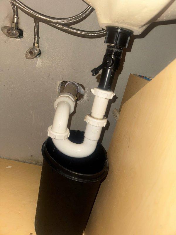 Responded to water leak in downstairs bathroom and identified failed pop-up assembly beneath sink as source of leak. Removed defective pop-up drain component and installed new replacement unit, ensuring proper seal and connection to existing P-trap assembly. Tested system for leaks and verified proper drainage function upon completion.
