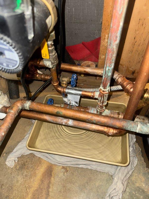 Responded to leak in domestic hot water recirculating line servicing tanked water heater system. Upon arrival, identified active leak at copper piping connection in recirculation loop. Isolated affected section using existing shut-off valves, drained line, and repaired compromised joint. System exhibited moderate oxidation and patina consistent with age of installation. Verified repair integrity, restored water flow, and confirmed no additional leaks present. Recirculating pump and associated valves tested and operating properly. Drip tray positioned beneath repair area as precautionary measure.