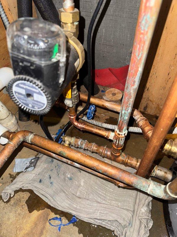 Responded to leak in domestic hot water recirculating line servicing tanked water heater system. Upon arrival, identified active leak at copper piping connection in recirculation loop. Isolated affected section using existing shut-off valves, drained line, and repaired compromised joint. System exhibited moderate oxidation and patina consistent with age of installation. Verified repair integrity, restored water flow, and confirmed no additional leaks present. Recirculating pump and associated valves tested and operating properly. Drip tray positioned beneath repair area as precautionary measure.