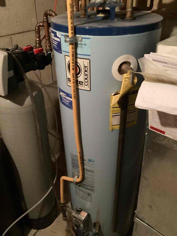 Responded to service call for two leaking outdoor hose bibbs requiring replacement at front and back of property. Upon inspection, determined both spigots were located in extremely tight, inaccessible areas beneath deck structure with limited clearance. Provided estimate for complete replacement of both hose bibbs, noting that adequate access points would need to be created through existing structure before replacement work could proceed. Documented existing conditions including accumulated debris in work area and current plumbing configuration at water heater location to assess supply line routing for outdoor fixtures.