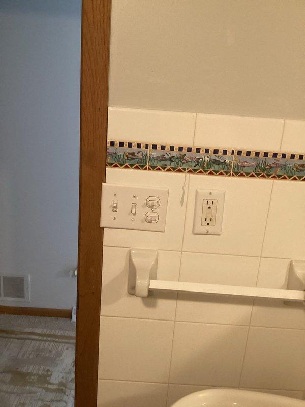 Responded to no power condition affecting multiple areas of residence. Diagnosed and resolved tripped GFCI outlet in upstairs bathroom that was controlling power to basement bathroom. Identified and corrected loose electrical connections at kitchen microwave outlet that were causing breaker trips during appliance operation. Diagnosed faulty light switch in basement living room causing intermittent operation. Reset GFCI protection and verified proper circuit function. Provided estimate for light switch replacement and documented all findings with photographic evidence of electrical panel and affected bathroom area.