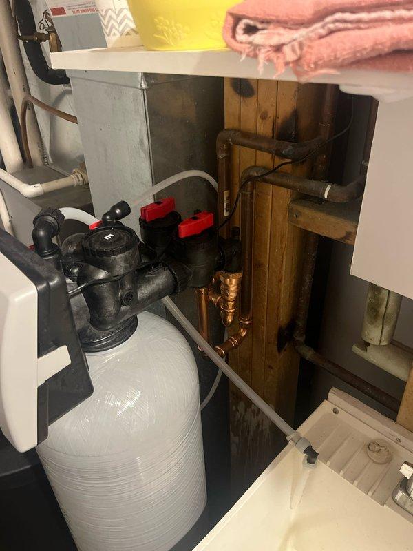 Responded to service call and successfully installed a new two-piece water softener system in the utility closet space. The installation included connecting copper plumbing lines with brass fittings to the control valve assembly, ensuring proper integration with the existing water supply system. All connections were tested and verified operational upon completion.