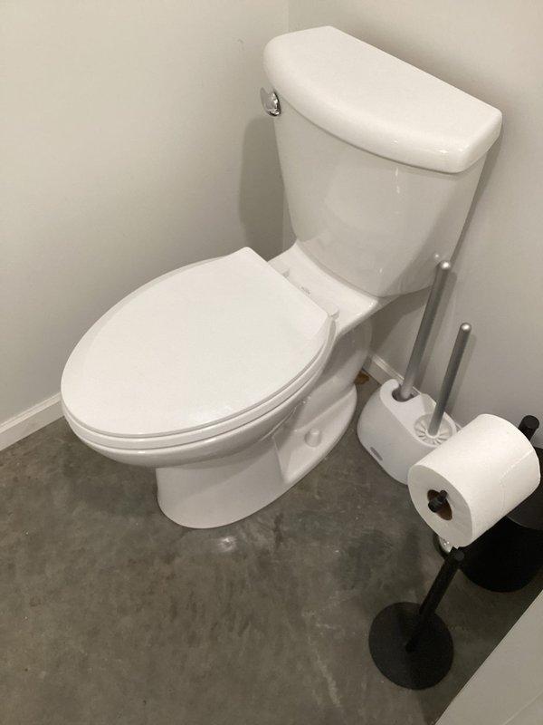 Responded to service call for loose toilet installation. Upon arrival, confirmed toilet was not properly secured to floor flange. Removed toilet from mounting bolts, inspected wax ring and flange for damage, and reinstalled toilet with proper seating and secure bolting to eliminate movement and ensure watertight seal.