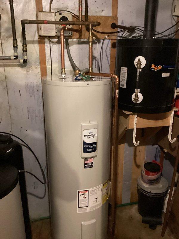Replaced existing 80-gallon electric water heater with new 50-gallon Bradford White electric water heater. Disconnected solar line from old unit, drained and removed existing water heater from basement utility area. Installed new Bradford White 50-gallon electric water heater with proper copper piping connections, temperature and pressure relief valve, and shut-off valves. Filled tank, restored electrical power, and verified all connections for proper operation with no leaks detected. System tested and functioning correctly upon completion.