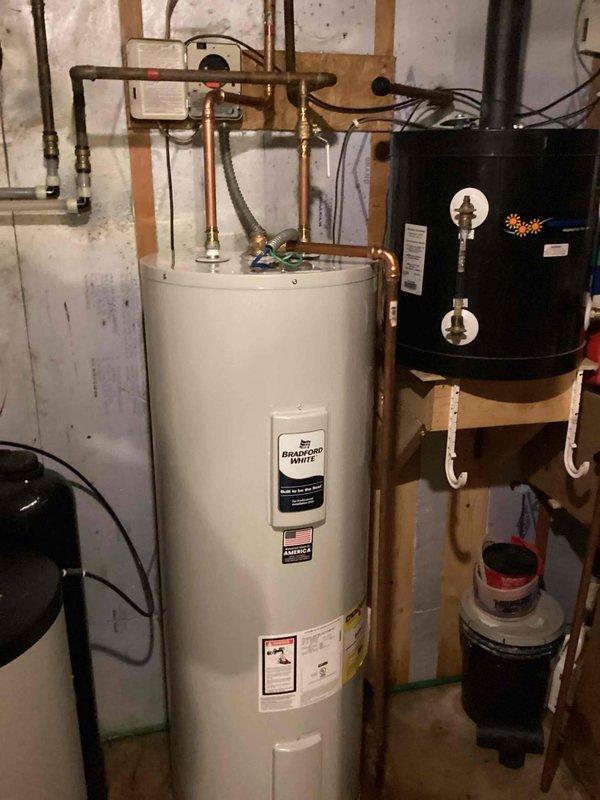 Replaced existing 80-gallon electric water heater with new 50-gallon Bradford White electric water heater. Disconnected solar line from old unit, drained and removed existing water heater from basement utility area. Installed new Bradford White 50-gallon electric water heater with proper copper piping connections, temperature and pressure relief valve, and shut-off valves. Filled tank, restored electrical power, and verified all connections for proper operation with no leaks detected. System tested and functioning correctly upon completion.