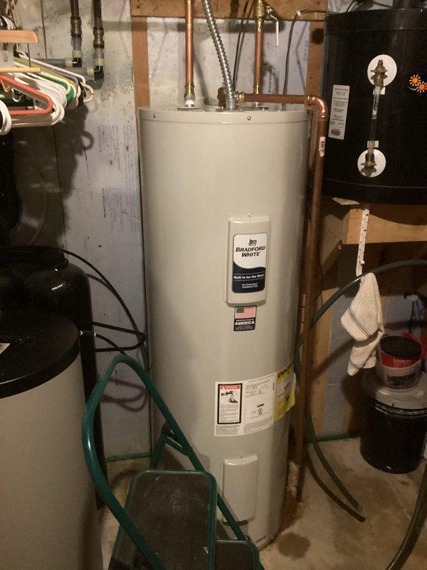 Completed electrical hookup for Bradford White water heater as a no-charge callback service. Removed old wiring from previous solar water heater installation and installed new metal flex conduit with proper retaining nut for secure wire entry into the water heater junction box. Reconnected all electrical connections at the water heater per manufacturer specifications and code requirements, ensuring safe and proper operation of the unit.