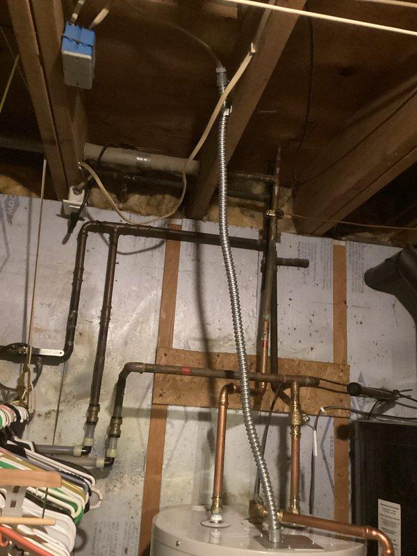 Completed electrical hookup for Bradford White water heater as a no-charge callback service. Removed old wiring from previous solar water heater installation and installed new metal flex conduit with proper retaining nut for secure wire entry into the water heater junction box. Reconnected all electrical connections at the water heater per manufacturer specifications and code requirements, ensuring safe and proper operation of the unit.