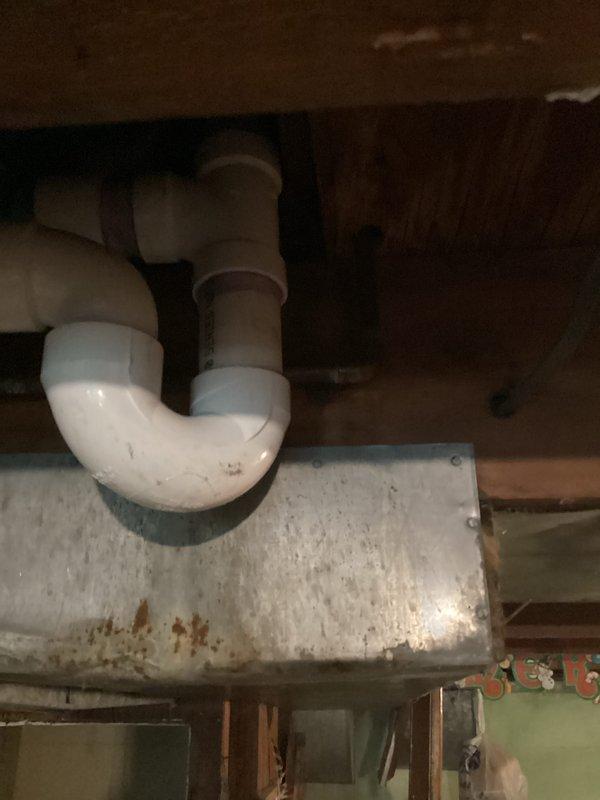 Responded to drain leak in shower system. Upon arrival, found broken 1.5-inch PVC drain line beneath shower requiring immediate repair. Replaced damaged section of drain pipe and installed new elbow fitting to restore proper drainage function. Secured all connections with appropriate PVC fittings and ensured P-trap configuration remained intact for proper water seal. Tested system for leaks and verified complete repair of drainage assembly.