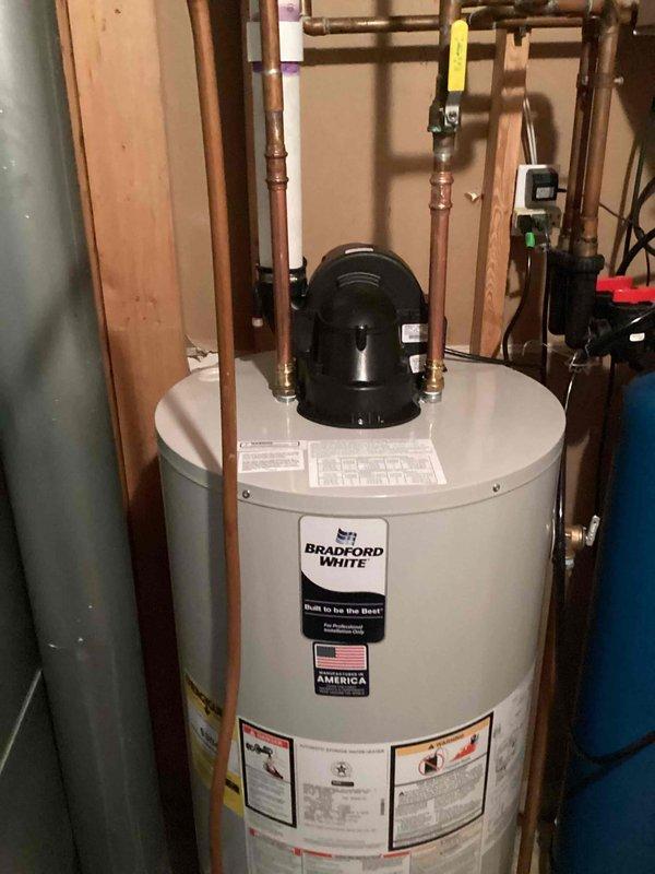 Removed and properly disposed of existing water heater from residential utility room. Installed new 50-gallon power vent natural gas Bradford White water heater with all necessary connections including copper supply lines, gas line, and venting system. Filled tank, performed initial startup procedures, and tested all operational functions to ensure proper heating and venting performance. System is operating correctly with no leaks detected.