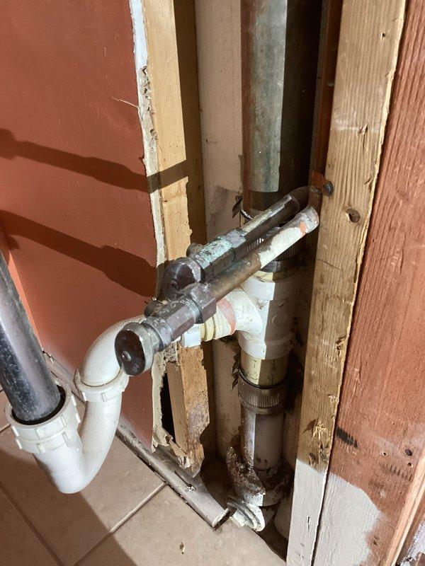 Responded to service call for bar sink removal and plumbing disconnection. Upon arrival, cut and removed existing drain line and water supply lines serving the old bar sink. Disconnected and removed P-trap drain assembly from the drainage system. Cut and properly capped both 1/2" hot and cold water supply lines to eliminate the bar sink connection points. Secured loose PVC piping and water connections in the wall cavity to prevent future interference. Restored water service to the home and performed system check to verify all connections were watertight and functioning properly with no leaks detected.