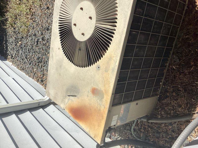 Responded to no cooling call on 10+ year old system. Found condenser fan motor catching and failing to operate properly. Removed fan shroud to access and assess condenser fan motor assembly for replacement recommendation.
