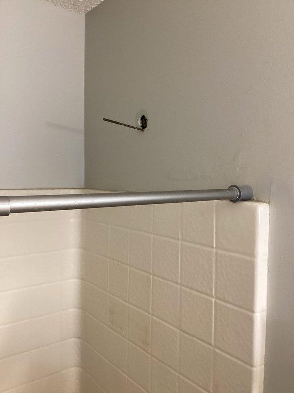 Responded to upstairs shower leak causing water damage to ceiling in bathroom below. Diagnosed faulty tub spout with diverter that leaked when shower function was engaged. Removed defective tub spout assembly and installed new replacement unit. Tested both tub and shower operations to verify complete leak elimination. Applied caulking around tub spout perimeter to ensure proper seal and prevent future moisture intrusion.