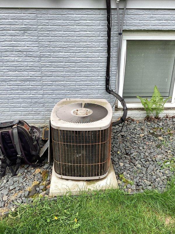 Responded to no cooling call on aging residential air conditioning system. Upon arrival, discovered condenser fan motor humming but not rotating, preventing proper heat rejection from the outdoor unit. Diagnosed failed condenser fan motor as primary issue. Unit interior showed significant debris accumulation and weathering consistent with 10+ years of outdoor exposure. Collected diagnostic fee and documented equipment condition with photos showing deteriorated condenser coil fins, corroded electrical components, and substantial environmental debris buildup in compartment. Coordinated with project manager to schedule repair and provided customer with detailed estimate for condenser fan motor replacement.