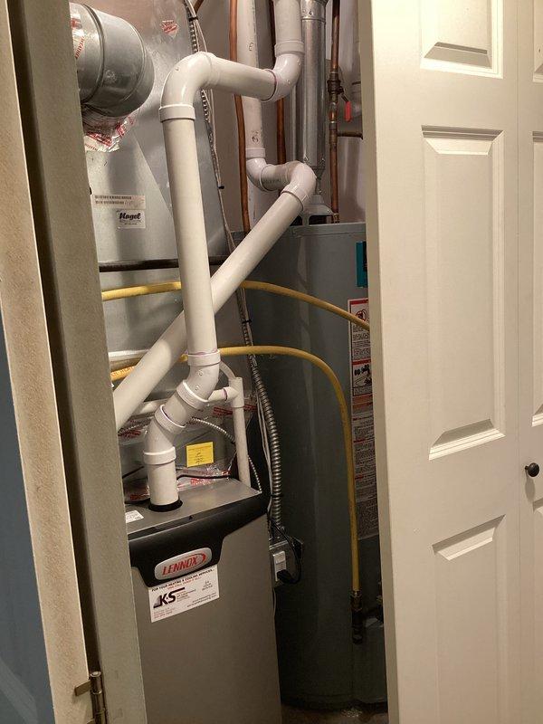 Technician arrived during scheduled window to assess existing 50-gallon atmospheric water heater for replacement. Conducted thorough inspection of current installation located in utility closet adjacent to Lennox furnace system. Evaluated existing plumbing configuration including copper supply lines, gas connections with flexible yellow gas line, and venting arrangement with existing PVC and metallic vent piping. Customer expressed interest in upgrading to a higher recovery, more efficient water heater model to improve hot water availability. Documented current installation with photographs showing equipment placement, gas valve connections, supply line routing, and available clearances in confined utility space. Assessed compatibility requirements for upgraded unit including gas line capacity, venting modifications, electrical connections if applicable, and spatial constraints within existing mechanical room. Prepared detailed estimate for replacement with higher-efficiency water heat