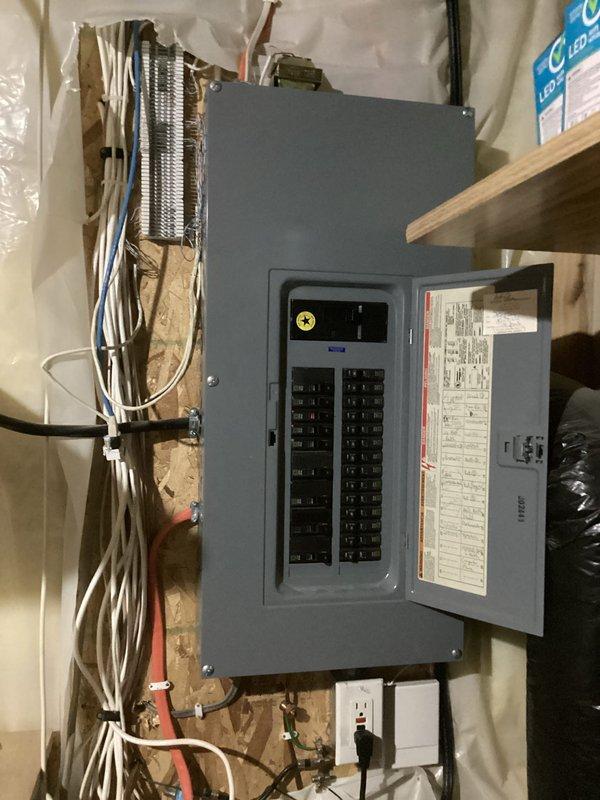 Responded to service call for non-functional GFCI outlet in garage. Upon inspection, determined the GFCI receptacle had been improperly wired with line and load connections reversed, preventing proper ground fault protection and causing malfunction. Disconnected and rewired the GFCI outlet according to manufacturer specifications and NEC standards, ensuring correct line-side and load-side connections. Tested unit for proper operation and verified ground fault protection functionality. Documented electrical panel and work area conditions with photographs for service records.