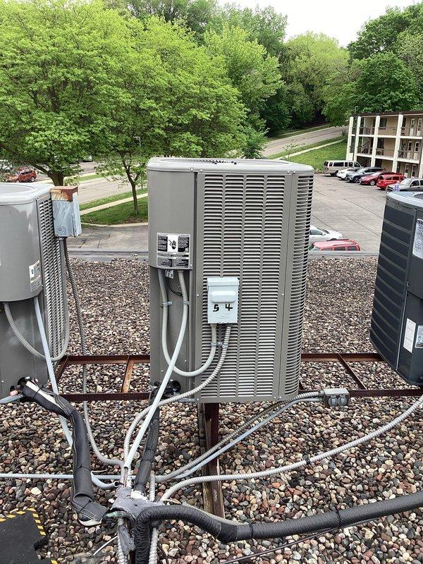 Responded to no cooling complaint on multi-unit heat pump system. Diagnosed unit #51 with failed condenser fan motor and starter capacitor, and unit #54 with failed contactor. Replaced fan motor, starter capacitor, and contactor on respective units, restoring full cooling operation to both heat pumps.