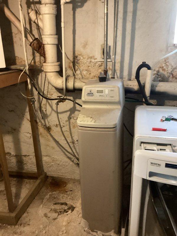 Responded to service call for water heater and water softener evaluation. Upon arrival, assessed existing 40-gallon atmospheric water heater and single-piece water softener system in basement utility area. Documented current equipment condition and configuration, including existing plumbing connections and spatial constraints. Provided comprehensive estimate for complete replacement of both the water heater and water softener unit. Photographed existing installation for reference and documentation purposes.