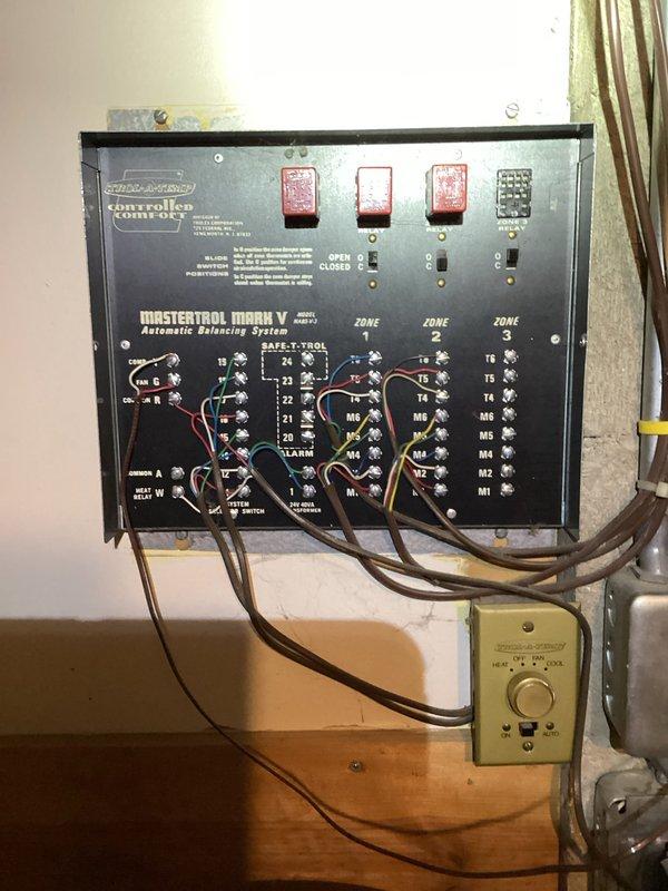 Responded to no cooling complaint on residential Lennox air conditioning system. Diagnosed failed Mastertrol Mark V automatic balancing zoning system control panel preventing proper system operation. Bypassed failed zoning controls and landed condenser wire directly at furnace to restore cooling functionality.