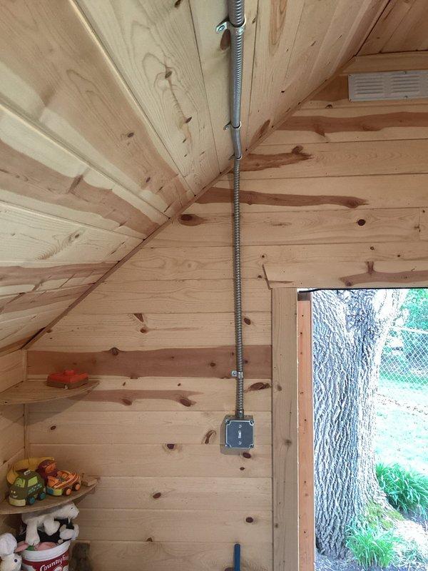 Installed dedicated electrical circuit to detached exterior shed structure. Routed new circuit from main panel through garage using metal conduit, transitioned to PVC conduit down exterior wall, and ran 12-3 UF wire through 45-foot trench to shed. Installed code-compliant double-pole disconnect at shed. Within structure, utilized surface-mount wiremold conduit to wire two evenly-spaced disk lights controlled by single switch, and installed two outlet locations on opposing walls. All work completed to current electrical code requirements.