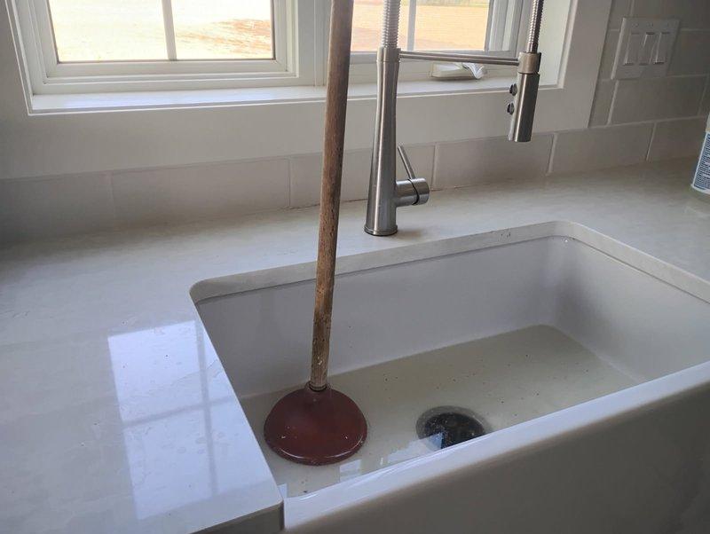 Responded to service call for burst pipe in wall affecting kitchen area. Upon arrival, confirmed water supply had been shut off and no active leaking was present. Customer also reported drain line backing up in both kitchen and laundry areas. Attempted to clear drain line blockage through laundry drain access point using standard clearing methods without success. Due to severity of blockage, referred customer to Rochester Drain Rite for specialized drain line clearing services.
