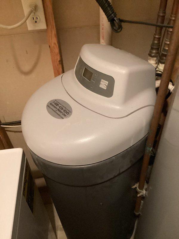 Responded to service call for aging water softener system experiencing leakage issues. Upon arrival, conducted thorough inspection of existing white cylindrical water softener unit with digital control panel, identifying advanced age and active leak requiring immediate attention. Evaluated overall system condition, plumbing connections, and copper pipe infrastructure to determine viability of repair versus replacement. Prepared and presented two comprehensive replacement estimates: one for installation of customer-supplied water softener equipment and one for complete system replacement with contractor-provided unit, including all necessary plumbing modifications and connections.
