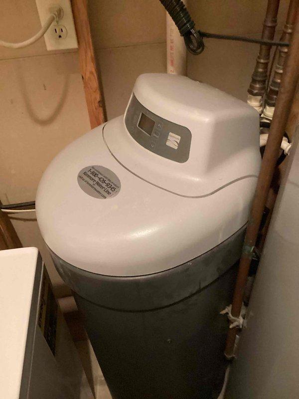 Responded to service call for aging water softener system experiencing leakage issues. Upon arrival, conducted thorough inspection of existing white cylindrical water softener unit with digital control panel, identifying advanced age and active leak requiring immediate attention. Evaluated overall system condition, plumbing connections, and copper pipe infrastructure to determine viability of repair versus replacement. Prepared and presented two comprehensive replacement estimates: one for installation of customer-supplied water softener equipment and one for complete system replacement with contractor-provided unit, including all necessary plumbing modifications and connections.