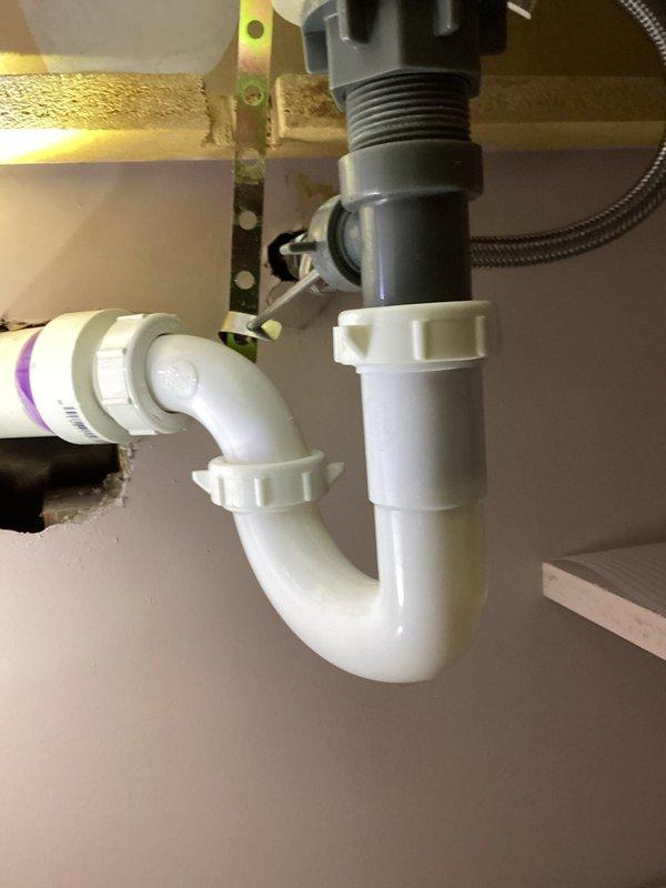 Responded to call regarding leak under sink in basement bathroom. Upon arrival, inspected the lavatory faucet supply lines and identified a loose compression nut on the cold side angle stop valve. Tightened the compression nut to proper specification and tested the system by running water through the fixture. Verified repair was successful with no further leakage detected. Photos documented the completed work.