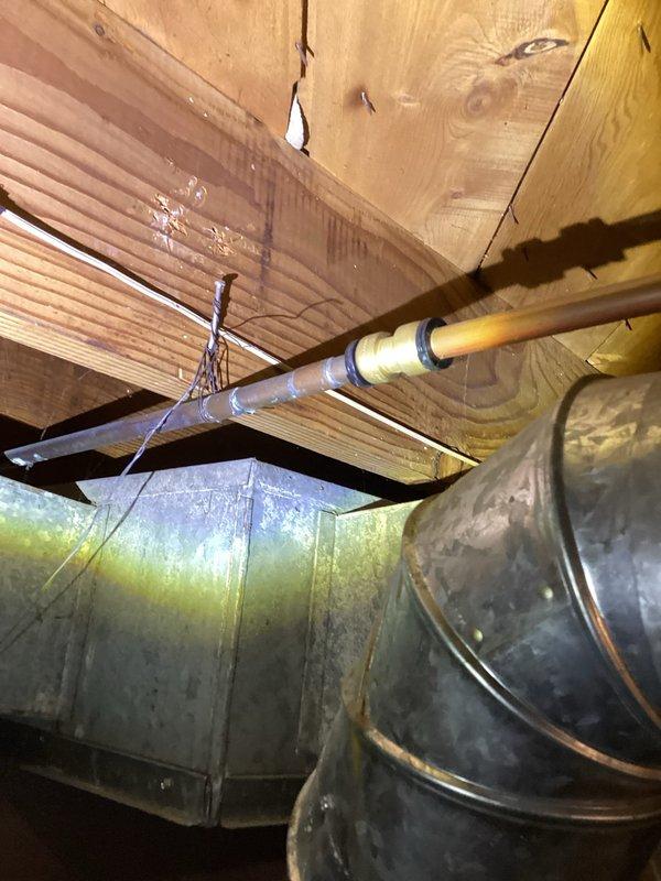 Responded to emergency call for burst pipe in basement equipment room. Upon arrival, located pin hole leak on copper water line near water heater. Shut off water supply to the home and assessed the damaged section. Cut out the compromised copper pipe and fitting, then installed new copper pipe and fittings to replace the failed section. Restored water service to the home and verified complete system integrity with no additional leaks detected.