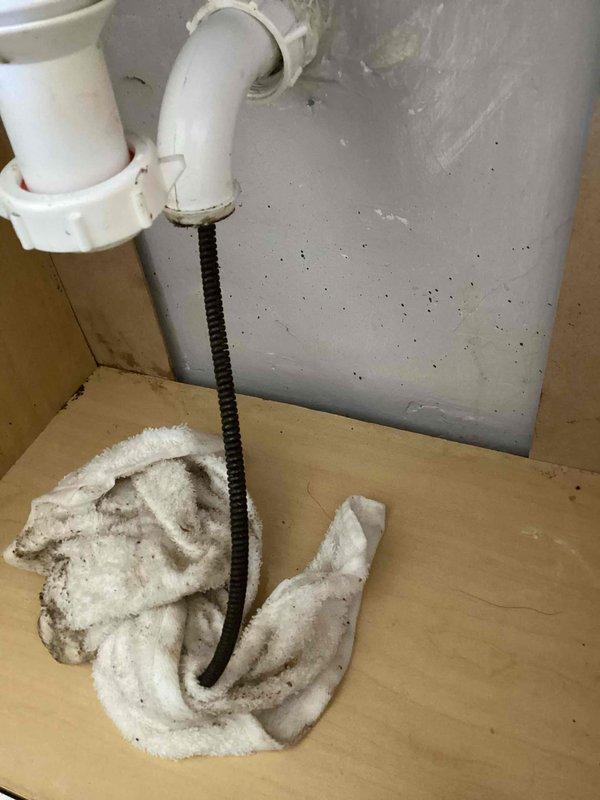 Responded to clogged upstairs lavatory sink with slow drainage. Attempted to clear blockage by running cable machine approximately 30 feet into drain line. Cable became lodged and stuck in the drain line during extraction attempt. Coordinated with Rochester Drain Rite to schedule follow-up appointment for specialized line clearing to remove stuck cable and resolve blockage.