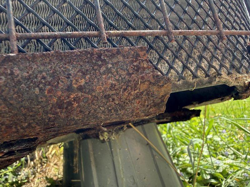 Responded to service call regarding rust damage on outdoor condensing unit. Upon inspection, discovered severe corrosion and deterioration of bottom pan and lower coil sections caused by repeated animal urine exposure. Metal housing exhibited extensive rust-through, compromising structural integrity of base components and potentially affecting refrigerant coils. Documented damage with photographs showing corroded framework and affected heat exchanger fins. Advised that replacement bottom pan may be insufficient due to extent of coil deterioration, and full condensing unit replacement may be necessary for proper system restoration.