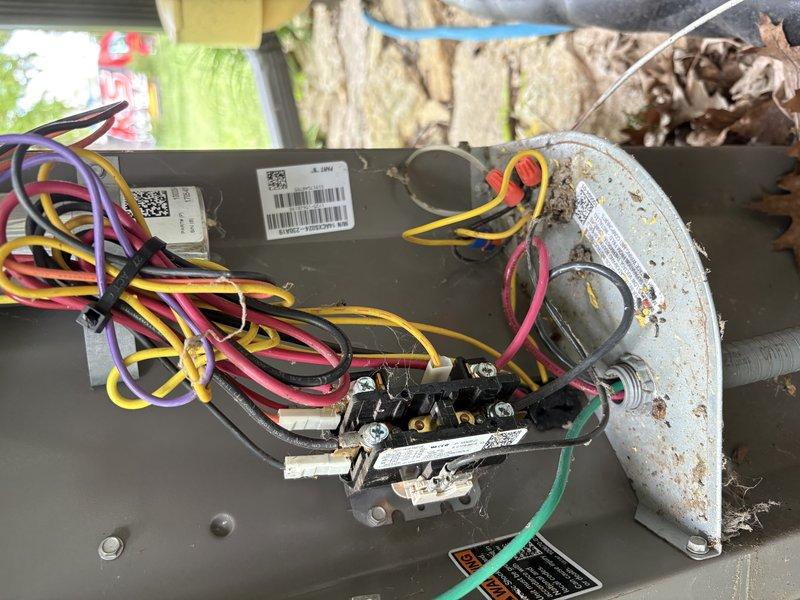 Responded to no cooling complaint on residential air conditioning unit. Upon inspection, discovered rodent damage to low-voltage control wiring with visible chew marks through multiple wire sections. Removed debris and leaf accumulation from unit interior. Repaired damaged wire sections, restored electrical connections, and verified system operation. Unit returned to normal cooling function.