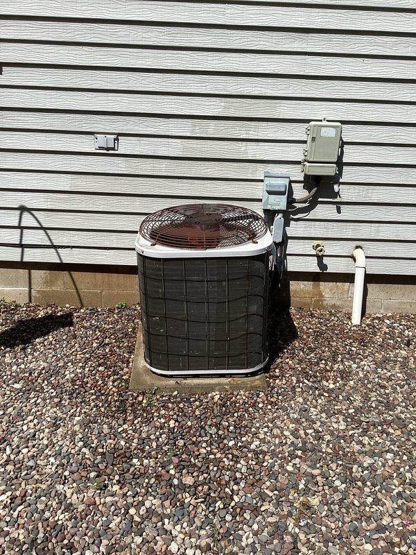 Responded to no cooling call on 30-year-old residential air conditioning system. Diagnosed failed dual run capacitor preventing compressor and condenser fan operation. Removed defective capacitor from electrical compartment and installed replacement capacitor with proper microfarad rating, restoring system to normal cooling operation.