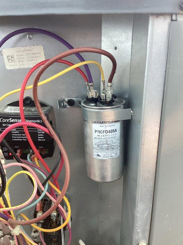 Responded to no cooling call on residential air conditioning system. Upon arrival, confirmed blower motor operating but no cool air delivery throughout home. Diagnostic inspection revealed two critical failures: broken wire connection at pressure switch and failed dual-run capacitor (40+5 MFD, 440/370 VAC). Repaired damaged wire connection to pressure switch, restoring proper safety circuit operation. Replaced defective capacitor with new unit under existing parts warranty. Verified proper electrical connections, tested system operation, and confirmed return to normal cooling function. Unit restored to full operational status.