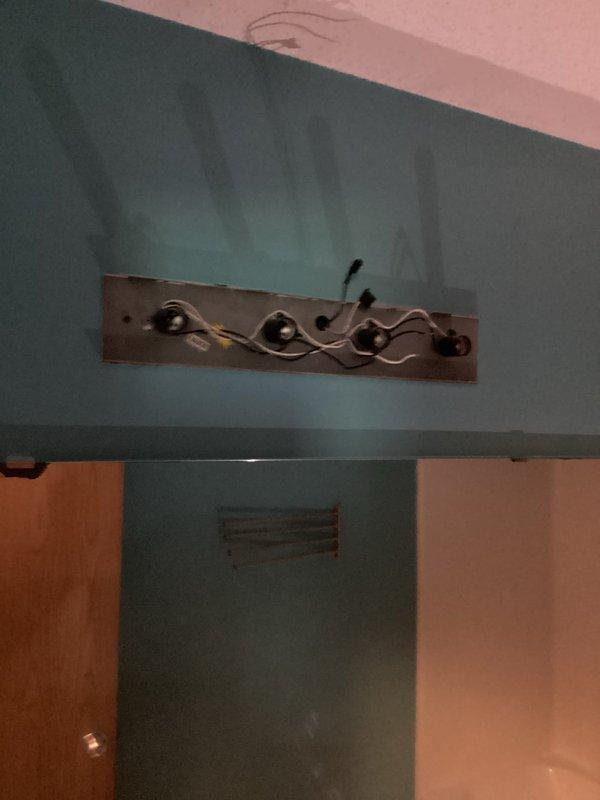 Responded to same-day service request for bathroom vanity light replacement. Removed existing light fixture and installed customer-supplied decorative vanity light fixture on teal-painted bathroom wall. Ensured proper electrical connections, secure mounting, and verified functionality of new fixture upon completion.