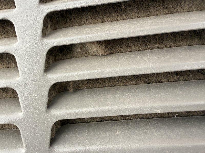 Responded to no cooling call on 1-year-old AC unit. Upon inspection, discovered failed capacitor and burned C wire caused by severely clogged condenser coil due to inadequate maintenance. Replaced damaged capacitor and C wiring, thoroughly cleaned clogged coil and entire outdoor unit to restore proper airflow and system operation. Unit tested and confirmed cooling restored to normal parameters.