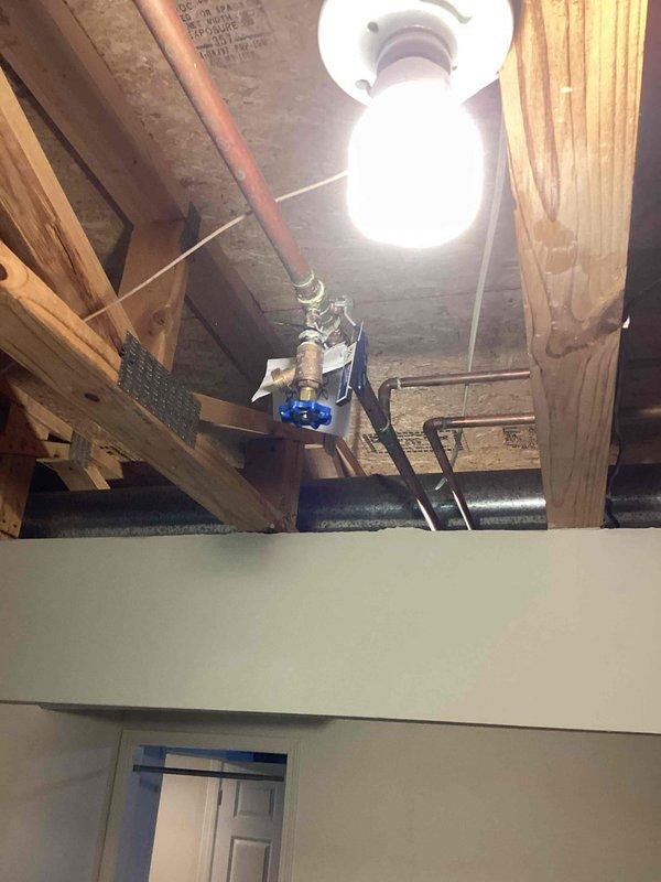 Responded to emergency call for leaking outdoor water line. Upon arrival, found burst pipe connected to exterior spigot and irrigation system located under deck. Pipe had frozen and ruptured due to exposure to winter elements. Accessed plumbing through interior crawl space where copper supply lines were routed. Cut damaged section of water line and installed permanent cap to prevent future freeze damage. Verified all connections were secure and leak-free before restoring system.