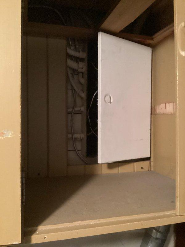 Completed electrical inspection for property assessment. Identified code compliance issue requiring GFCI outlet installation at washer location. Documented existing electrical panel within utility cabinet and non-compliant standard outlet at appliance area. Provided estimate for required GFCI protection upgrade to meet current electrical safety standards.