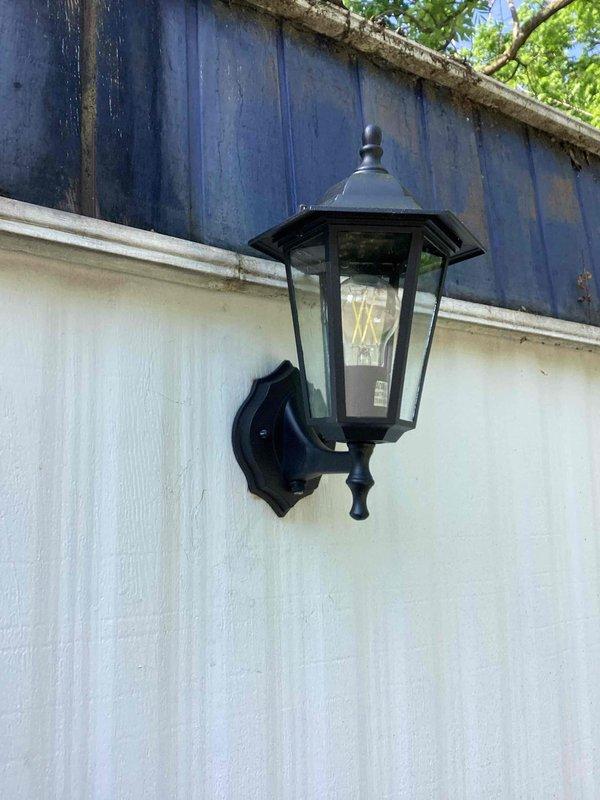 Responded to service call for non-functional porch light fixture. Upon arrival, verified power present at wall switch but no power reaching the exterior lantern-style light fixture. Diagnosed issue as failed dawn-to-dusk photocell sensor preventing proper operation. Explained sensor function and failure mode to homeowner, demonstrating how the photocell controls power to the fixture based on ambient light levels.