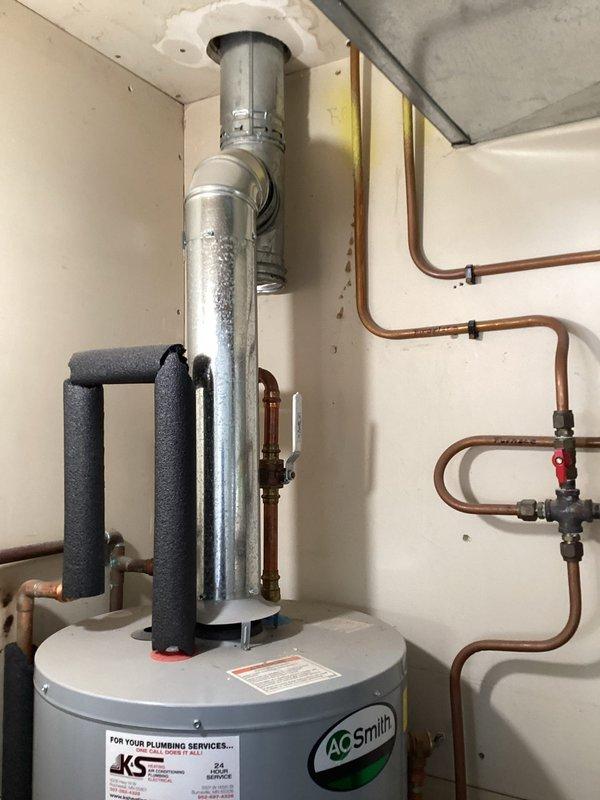 Responded to service call for leaking water heater. Upon arrival, assessed AO Smith tanked water heater and confirmed active leak requiring full unit replacement. Removed existing failed water heater and installed new AO Smith residential water heater unit with proper venting through ceiling exhaust system. Connected copper supply lines with appropriate shut-off valves and pressure relief valve. Installed insulated hot and cold water lines and verified all connections to existing plumbing manifold system. Ensured proper clearances around water softener unit and coordinated piping configuration with existing pressure gauge and water meter. Tested all connections for leaks, verified proper venting operation, and confirmed water heater functionality before completing installation.
