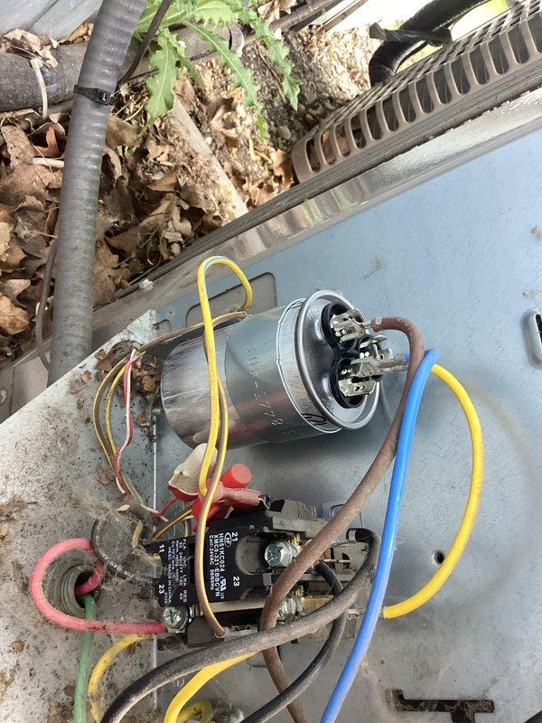 Responded to no cooling complaint on Goodman model 113NA801B-G outdoor condensing unit manufactured in June 2020. Upon arrival, diagnosed failed dual run capacitor preventing compressor and condenser fan motor operation. Removed defective capacitor and installed new dual run capacitor with proper microfarad ratings per manufacturer specifications, restoring system to normal cooling operation.