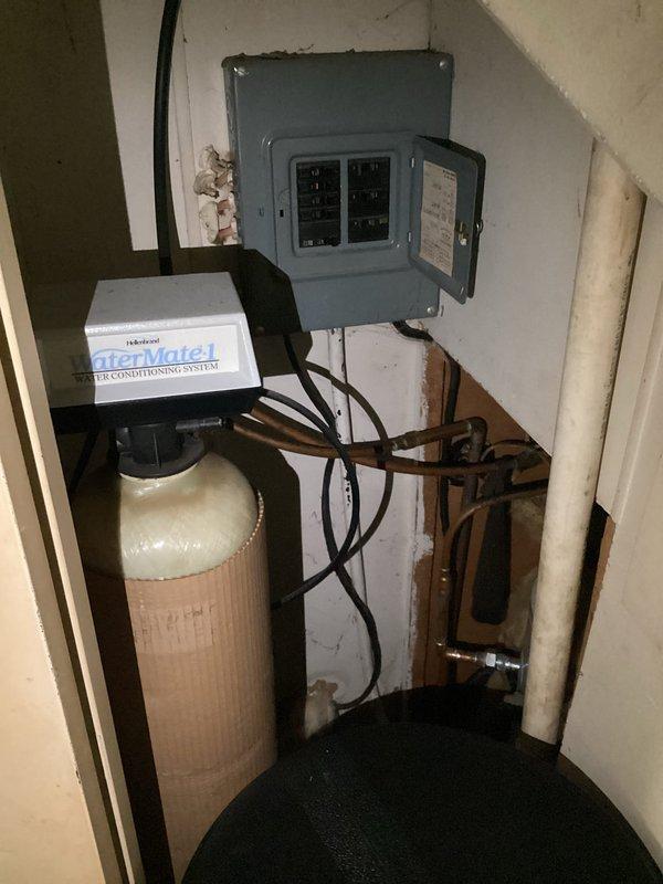 Responded to emergency call for active water leak at mobile home. Upon arrival, found electric water heater with continuous leak causing water accumulation on floor. Customer had already shut off water supply valve, but leak persisted until proper isolation valve was closed. Assessed water heater condition in confined crawl space area with limited access. Unit showed signs of failure requiring full replacement. Shut off power at electrical breaker panel and completed water supply isolation. Removed failed electric water heater unit from mechanical space. Installed replacement electric water heater with new connections to existing electrical service and plumbing lines. Verified all connections for proper seal and tested system operation. Restored power and water supply, confirmed no leaks present, and ensured proper hot water delivery throughout residence.
