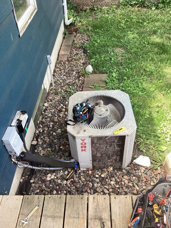 Responded to no cooling complaint on aging York AC system. Upon arrival, found evidence of previous ice buildup on evaporator coil and confirmed unit was low on R-22 refrigerant. Performed system diagnostics and pressure testing to verify refrigerant loss. Given the system's age (10+ years), deteriorated condition of both the air handler and outdoor condensing unit, obsolete R-22 refrigerant requirements, and overall wear evident throughout the equipment, recommended full system replacement rather than repair. Discussed replacement options with property owner due to diminishing availability and increasing cost of R-22 refrigerant, as well as the likelihood of additional component failures in the near future.