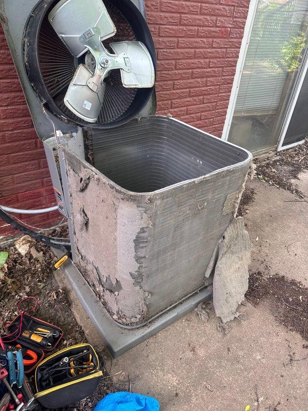 Responded to no cooling complaint on residential air conditioning system. Upon arrival, diagnosed failed capacitor caused by restricted airflow from heavily soiled condenser coil. The outdoor unit exhibited significant deterioration of exterior finish and accumulated debris around the base, contributing to reduced system efficiency.

Replaced defective capacitor with proper OEM replacement to restore compressor and fan motor operation. Performed thorough condenser coil cleaning to remove built-up dirt, debris, and organic material that had restricted airflow and caused the unit to overheat. Cleaned condenser fins and removed obstructions from around the unit. Verified proper fan operation and airflow after repairs. System tested and confirmed operational with adequate cooling restored.