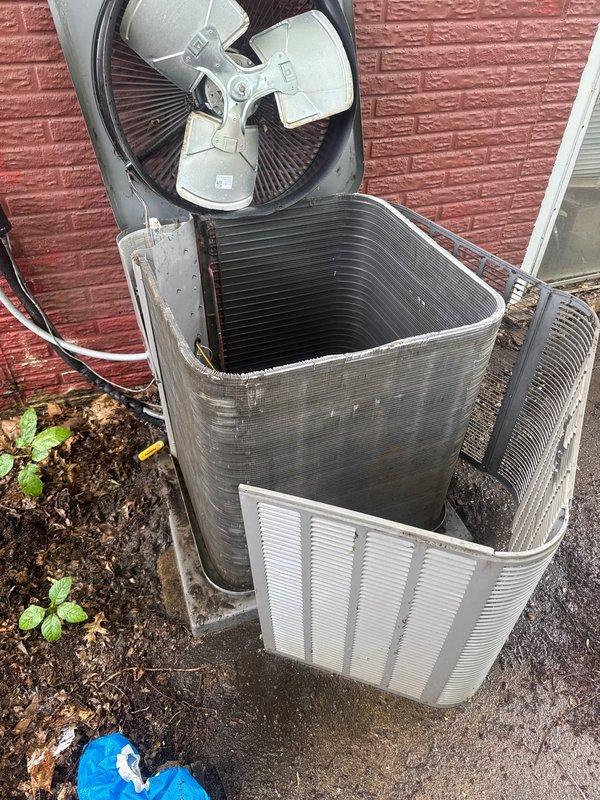 Responded to no cooling complaint on residential air conditioning system. Upon arrival, diagnosed failed capacitor caused by restricted airflow from heavily soiled condenser coil. The outdoor unit exhibited significant deterioration of exterior finish and accumulated debris around the base, contributing to reduced system efficiency.

Replaced defective capacitor with proper OEM replacement to restore compressor and fan motor operation. Performed thorough condenser coil cleaning to remove built-up dirt, debris, and organic material that had restricted airflow and caused the unit to overheat. Cleaned condenser fins and removed obstructions from around the unit. Verified proper fan operation and airflow after repairs. System tested and confirmed operational with adequate cooling restored.
