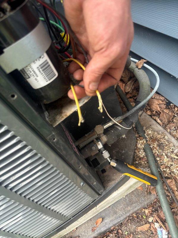 Responded to no cooling call on residential air conditioning system. Upon arrival, discovered low voltage wiring at outdoor condenser unit had been damaged by animal activity, causing the low pressure safety cutoff to malfunction and preventing system operation. Repaired damaged wires by splicing and securing connections, then tested system operation to verify proper cooling function was restored.