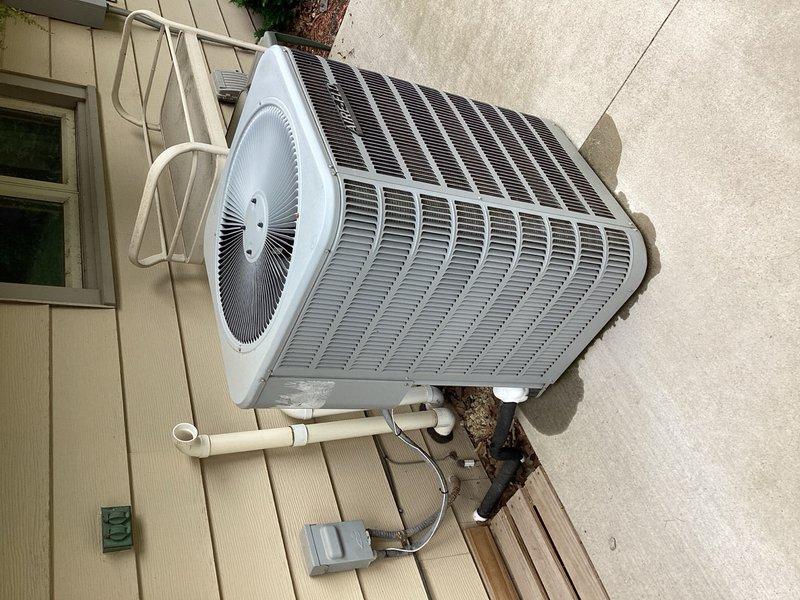 Responded to no cooling complaint on residential air conditioning system. Upon arrival, found evaporator coil completely frozen, preventing proper airflow and heat exchange. System was shut down to allow ice accumulation to thaw safely. Performed visual inspection of outdoor condensing unit and verified refrigerant line configuration. Documented equipment condition with photographs showing outdoor unit placement, refrigerant line routing, and overall system installation. Advised customer that frozen coil condition typically indicates underlying issues such as low refrigerant charge, restricted airflow, or failed metering device. Recommended scheduling follow-up appointment after complete thaw to conduct proper system diagnostics, check refrigerant levels, and provide repair estimate for identified deficiencies.