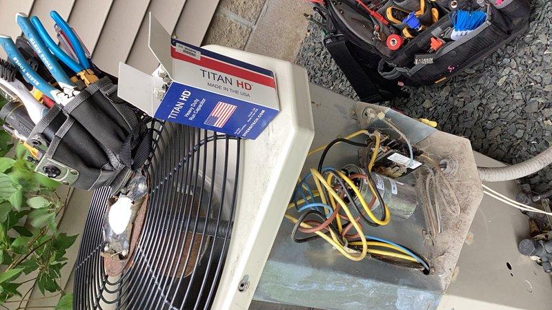 # HVAC Service Call - No Cooling Condition

Responded to a no cooling complaint affecting the entire residence. Upon arrival, confirmed the air conditioning system was blowing warm air with no temperature reduction. The unit, a twenty-year-old outdoor condensing unit, required immediate diagnostic evaluation.

## Diagnostic Findings

Performed comprehensive system inspection of the outdoor condenser unit. Identified a failed run capacitor as the root cause of the no cooling condition. The capacitor showed signs of electrical failure, preventing the compressor and condenser fan motor from operating properly. This component failure is common in aging HVAC systems, particularly those approaching or exceeding their expected service life.

## Repairs Completed

Replaced the defective capacitor with a new TITAN HD rated component, ensuring proper electrical specifications matched manufacturer requirements. Verified proper electrical connections and secure mounting of the new capacitor. Start