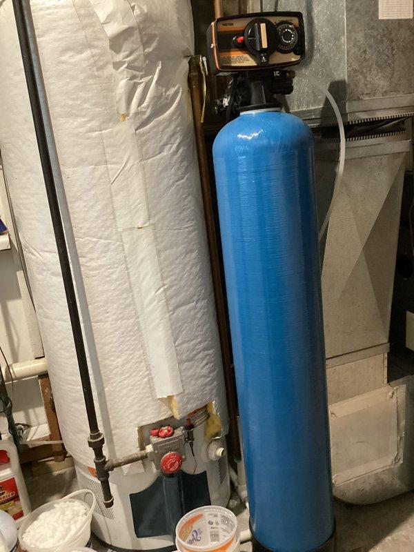 Arrived within scheduled 8-12 timeframe and conducted on-site evaluation of existing water treatment system in basement utility area. Assessed current single-tank water softener configuration and provided comprehensive estimate for upgrading to a two-piece water softener system with separate brine tank and resin tank for improved water conditioning capacity and efficiency.