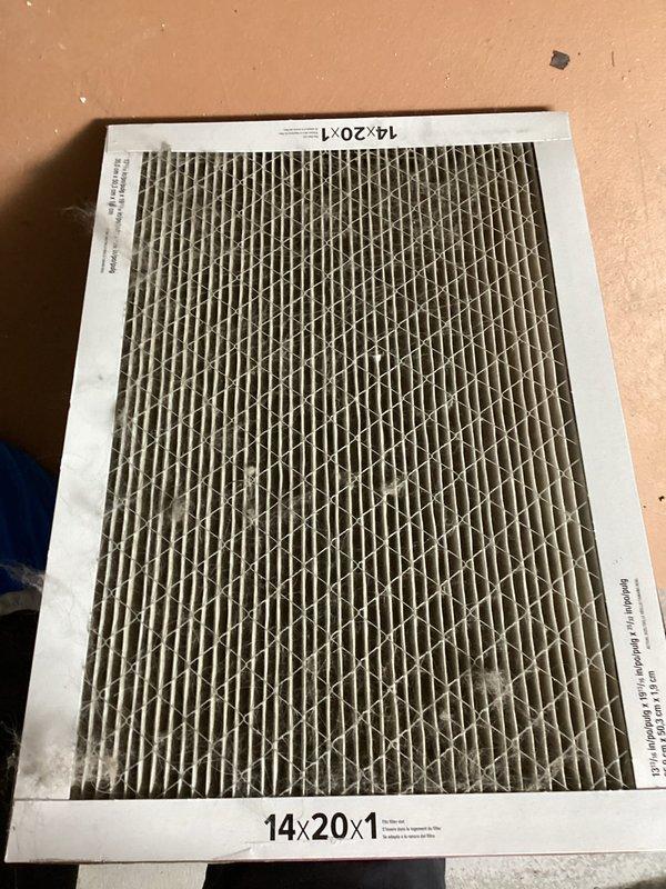 Responded to no cooling complaint on residential air conditioning system. Upon arrival, found outdoor condenser unit heavily soiled with debris accumulation on coil surfaces and top grille, restricting airflow and reducing heat transfer efficiency. Indoor air filter was severely clogged with dust and particulate matter, further impeding system performance. Replaced dirty 14x20x1 air filter with new unit. Advised customer that outdoor condenser requires professional coil cleaning and system would benefit from comprehensive preventive maintenance service to restore proper cooling capacity and efficiency.